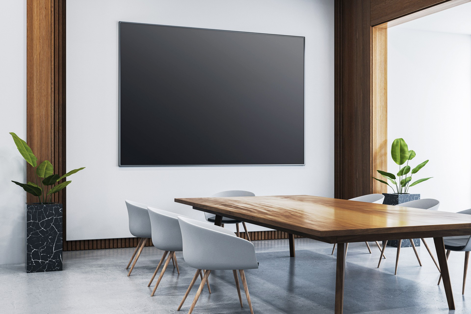 Modern conference room interior with blank black screen on the wall, wooden table, grey chairs, and minimalist decor in a clean office space. 3D Rendering
